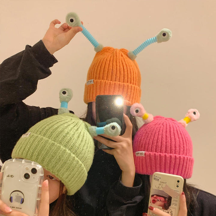 Person wearing a black Monster Beanie, staying warm in style