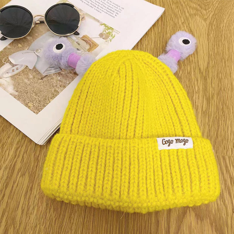 Studio shot of a pink Monster Beanie, soft nylon winter accessory