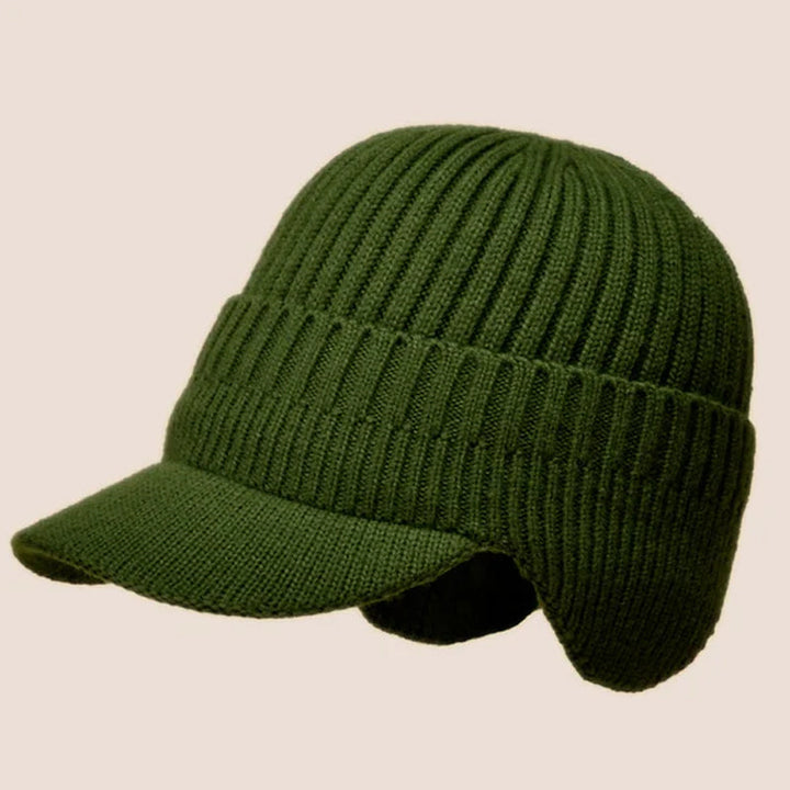 Outdoor shot of a warm beige knit beanie hat, featuring ear protection.