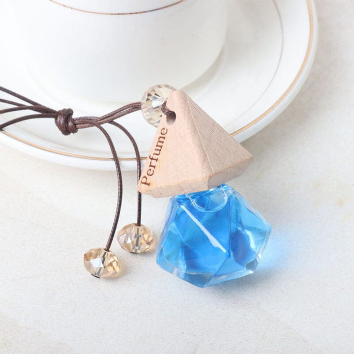 Small glass car air freshener vial, suspended, infusing vehicle with pleasant aroma, great car decor