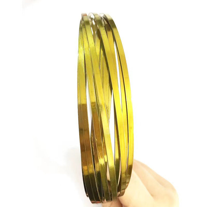 Unisex spinning spiral fidget bracelet next to a hand, emphasizing its portable size.