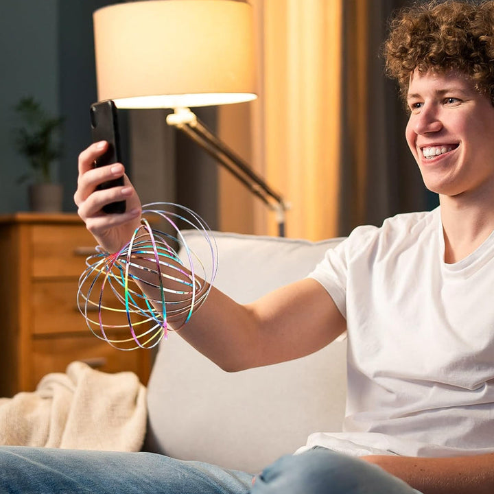 A person demonstrates a unisex spinning spiral fidget bracelet, actively spinning the device.