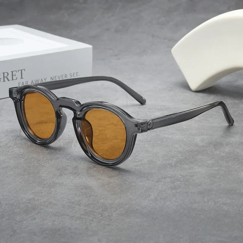 Amber tinted round sunglasses, unisex, with scratch-resistant lenses for style.
