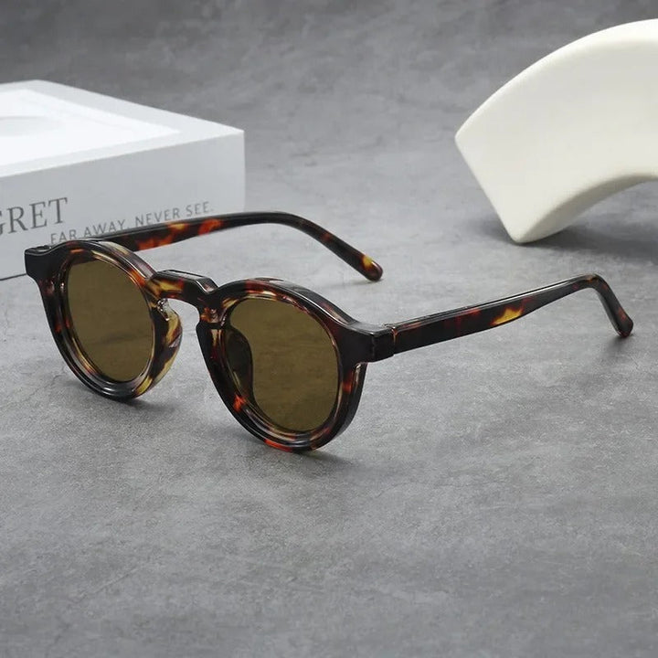 Modern graphite round sunglasses, unisex design, with tinted lenses.
