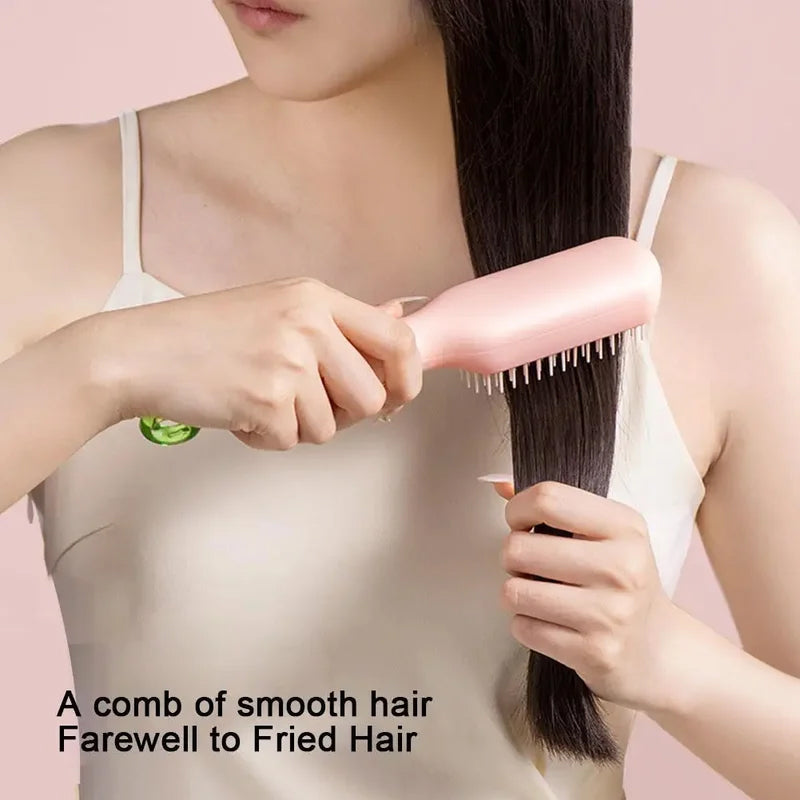 Detail shot of the hairbrush's self-cleaning mechanism, showing bristles retracting