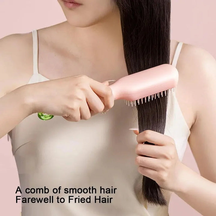 Detail shot of the hairbrush's self-cleaning mechanism, showing bristles retracting