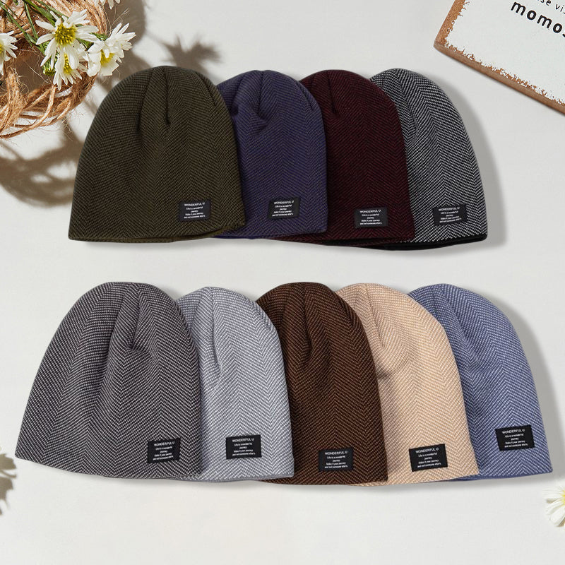 Close-up of a grey unisex thermal knit beanie hat, showing a soft, ribbed texture. Ideal for winter.