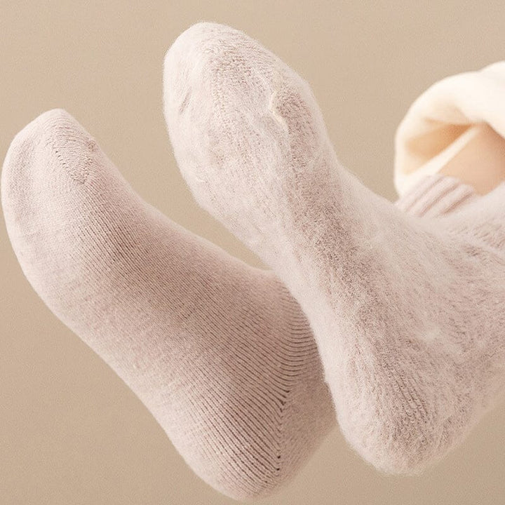 Model wearing black Unisex Thermal Winter Socks with winter boots, excellent cold protection