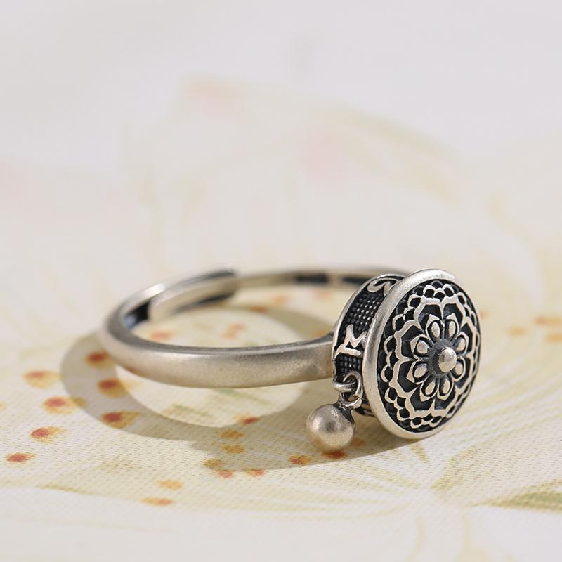 Detailed view of unisex copper spin ring, Tibetan prayer wheel motif, for mindfulness