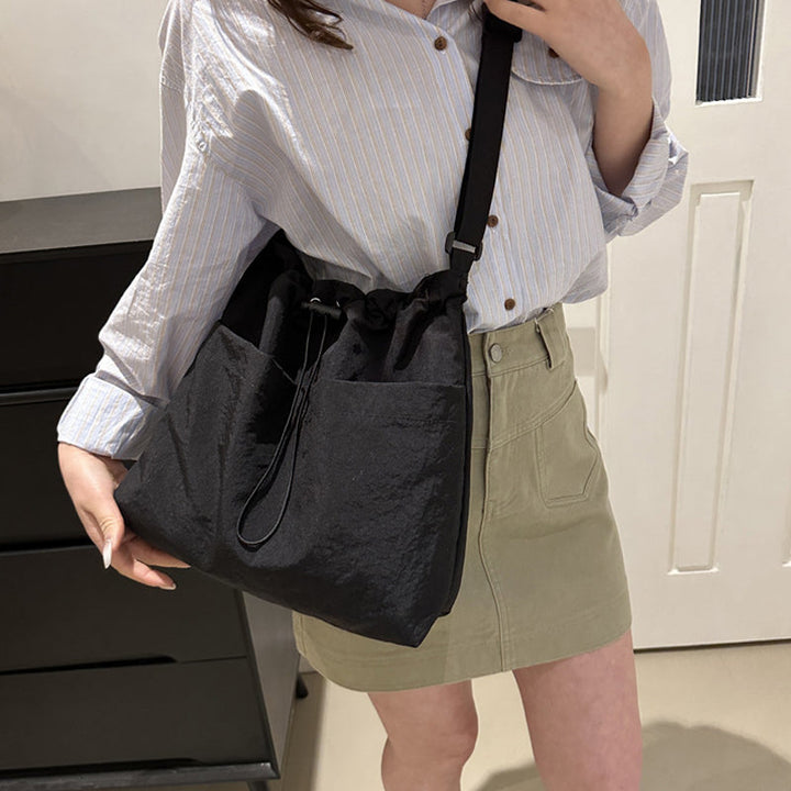 Unisex travel messenger bag in black nylon, ultra-light design for comfortable, casual wear