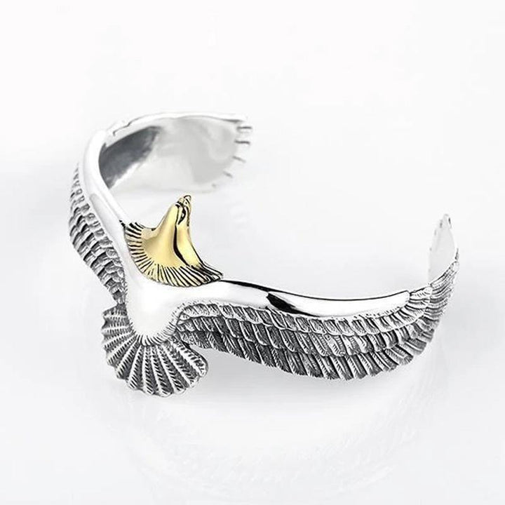 Hand modeling a unisex adjustable eagle design bracelet in polished copper, ideal for everyday wear.