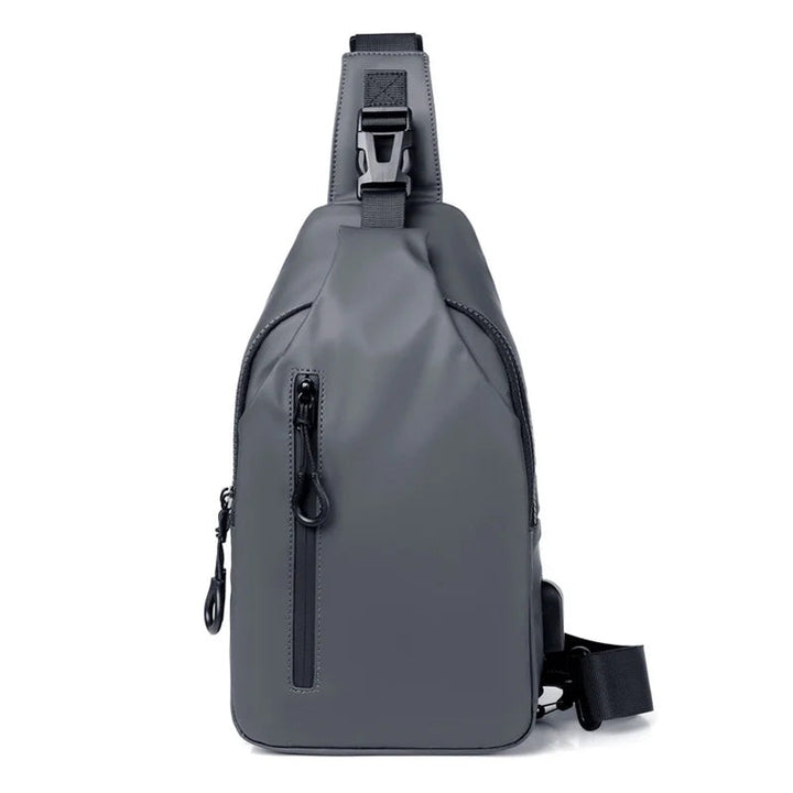 Traveler using a black unisex waterproof USB charging sling bag at an airport.