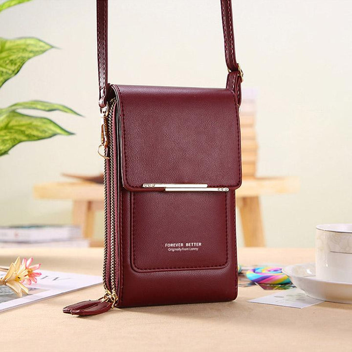 Detail shot of the adjustable strap on a black universal crossbody phone case. Durable PU leather accessory for travel.