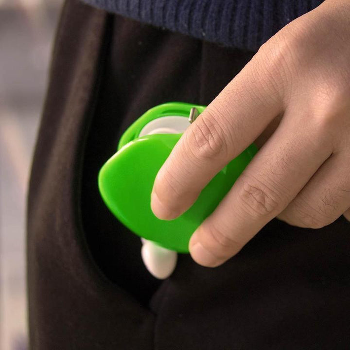 Universal Tangle-Free Cable Organizer fitting easily into a pocket with earbuds