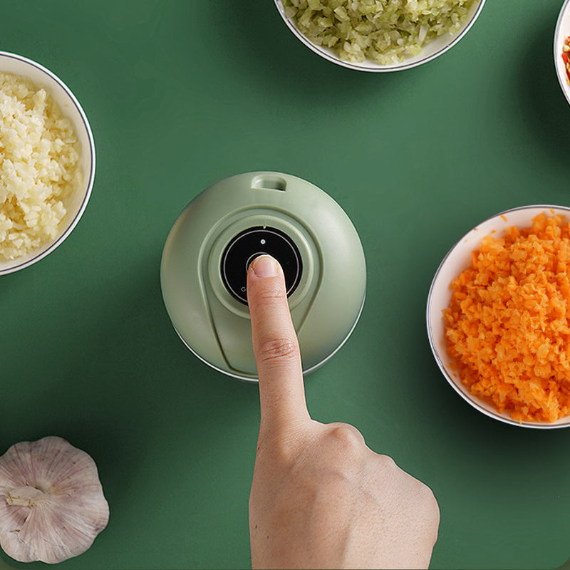 Mini electric chopper with visible food chamber, USB rechargeable for convenient kitchen use.