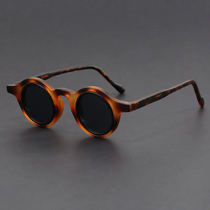 Unisex Velari round frame sunglasses on a white background, highlighting their sleek, modern aesthetic.