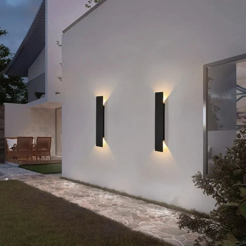 Weatherproof LED wall light with sleek aluminum design, ideal for enhancing outdoor spaces like patios and gardens.
