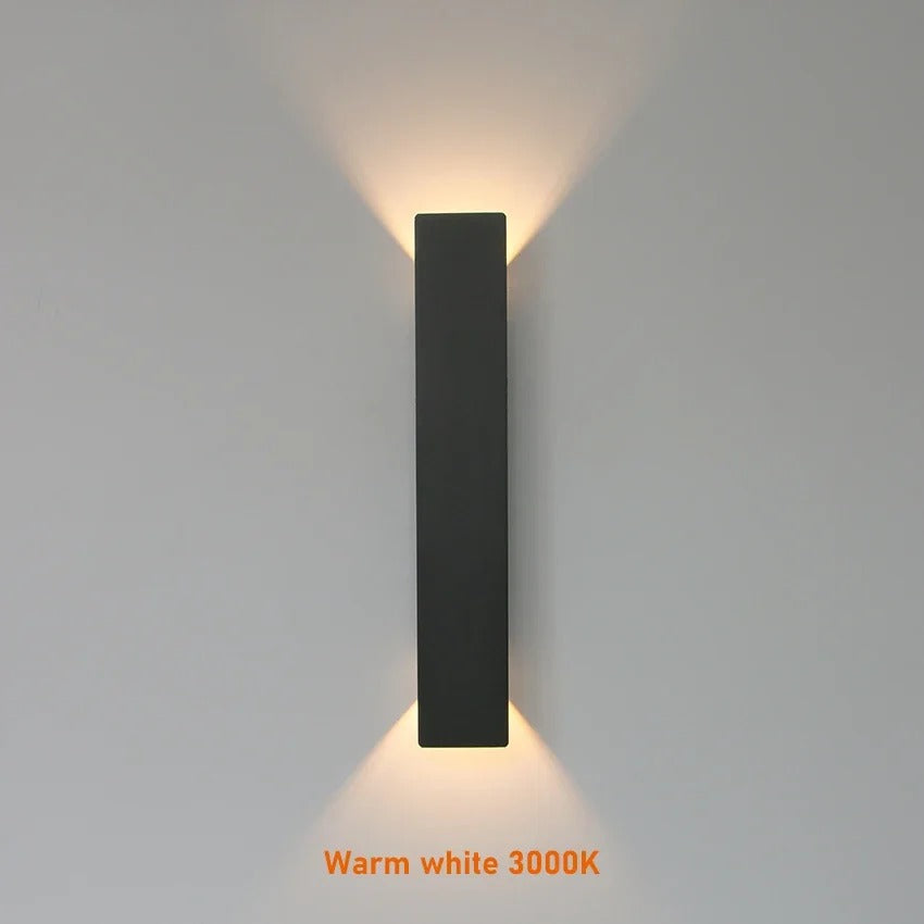Weatherproof LED wall light with sleek aluminum design, ideal for enhancing outdoor spaces like patios and gardens.