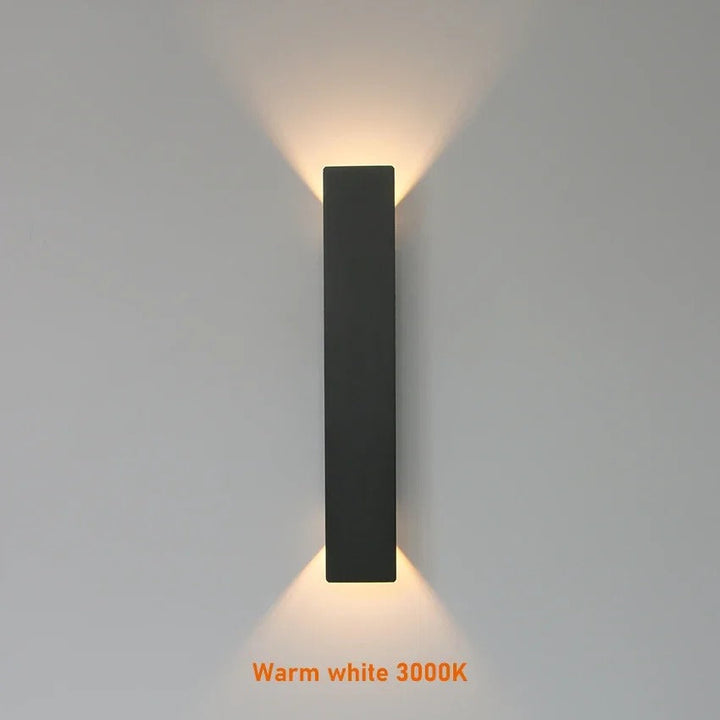 Weatherproof LED wall light with sleek aluminum design, ideal for enhancing outdoor spaces like patios and gardens.