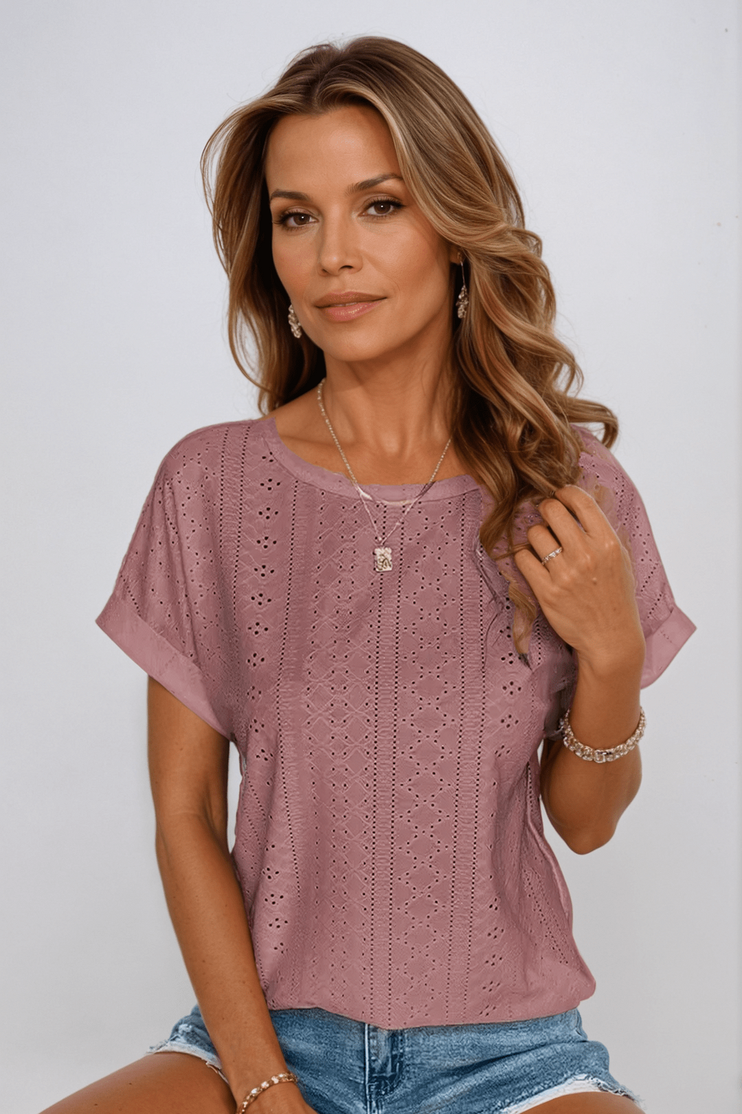 Relaxed fit women's short sleeve eyelet top, breathable & comfortable. Ideal for summer styles and everyday wear.
