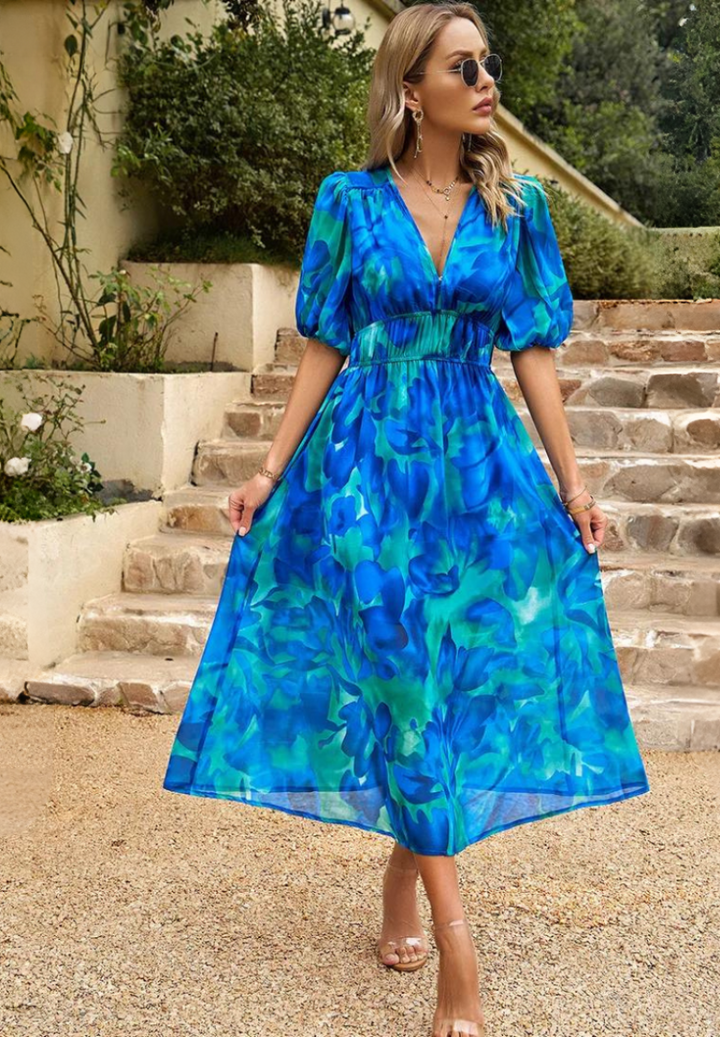 Back view of women's abstract print midi dress, showcasing unique pattern and flow
