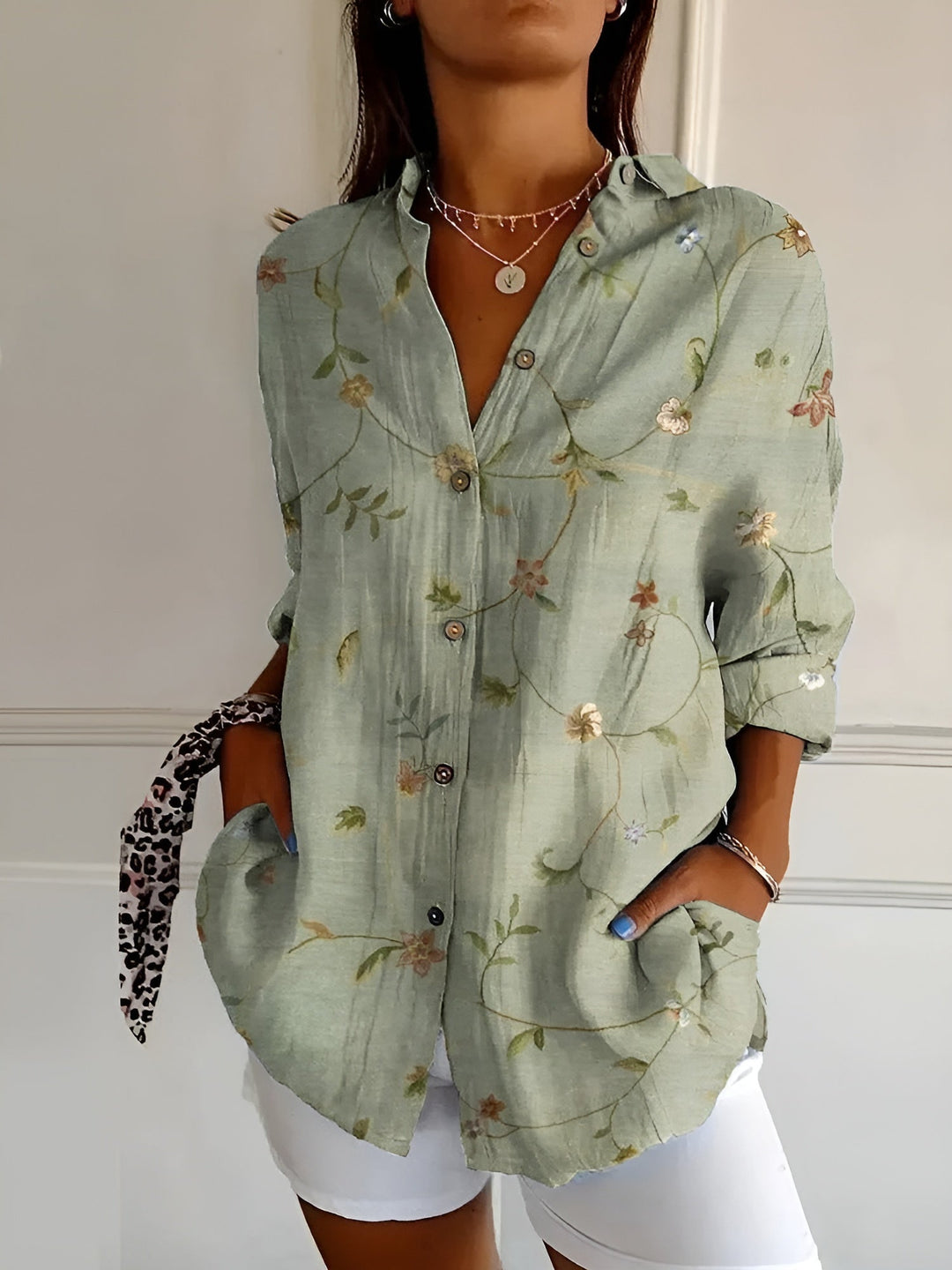 Stylish women's patterned abstract print split-neck blouse with long sleeves, relaxed fit.