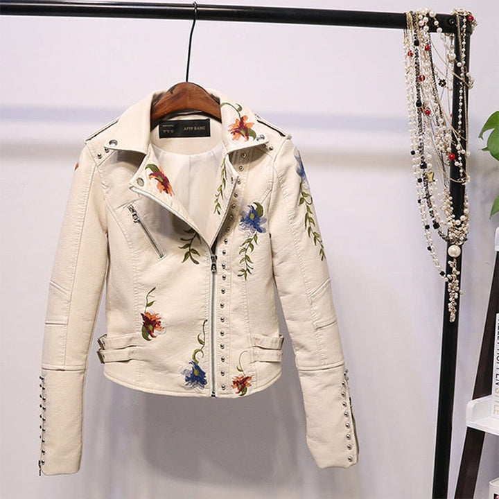 Long-sleeve women's embroidered biker jacket with an edgy asymmetrical zipper and floral artwork.