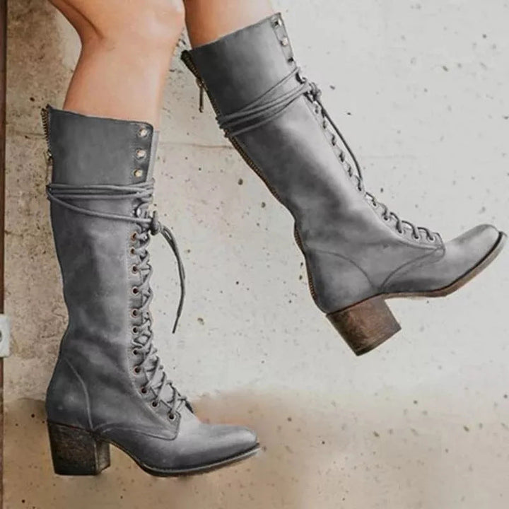 Fashionable women's knee-high boots, lace-up front, comfortable block heel for casual wear.