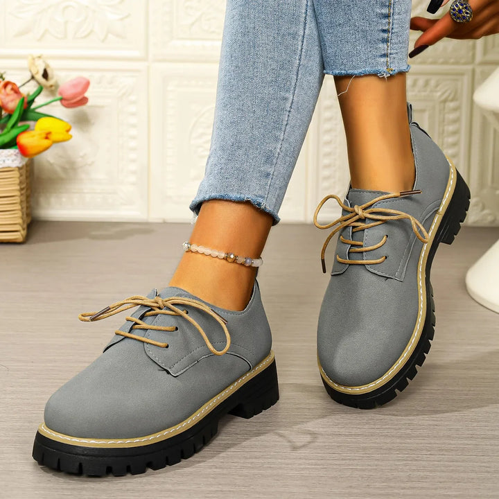Casual women's footwear: black lace-up platform shoes with a soft suede finish and elevated chunky sole.