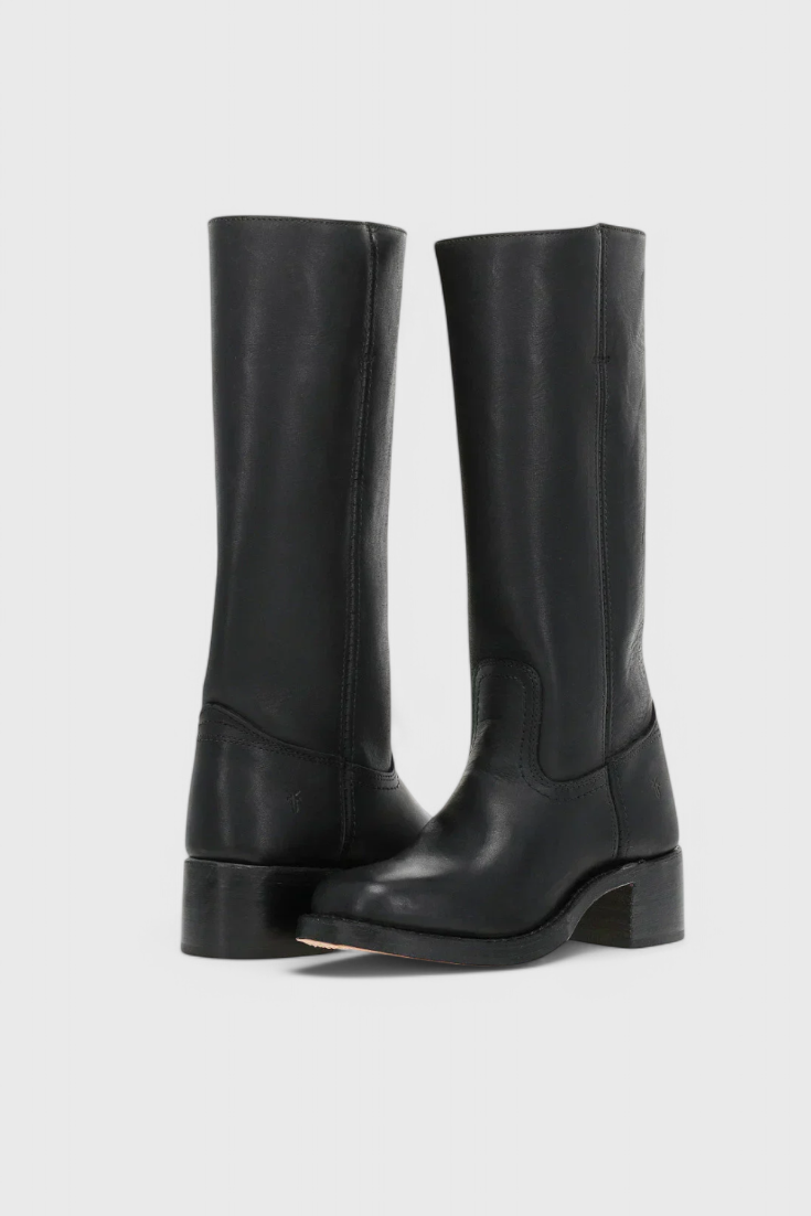 Close-up of women's black leather knee-high boots, highlighting the quality material and stitching.