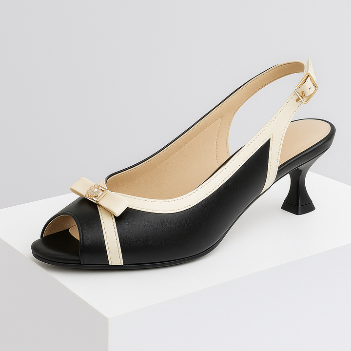 Close-up of the delicate bow detail on a women's leather slingback heel, showcasing elegant design.