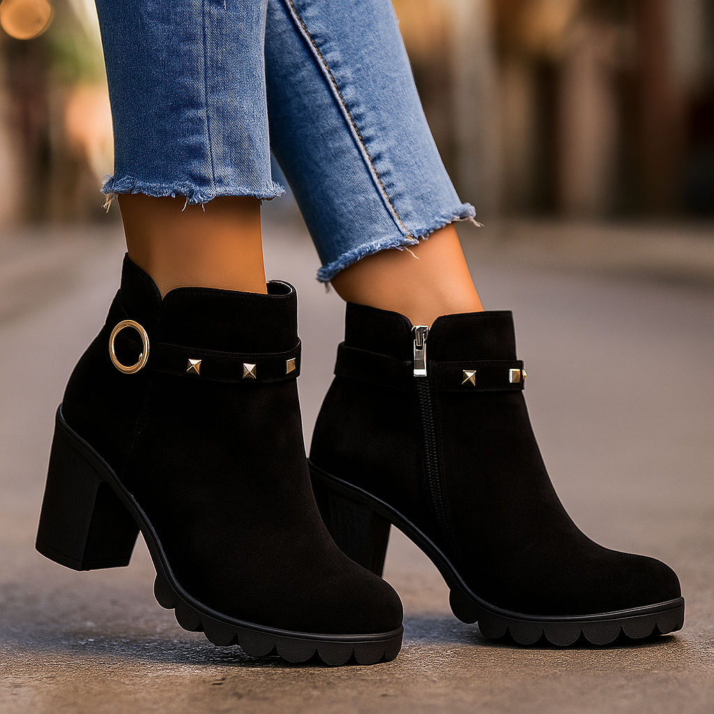 Close-up of women's fashion boots, showcasing silver stud details and a sturdy block heel