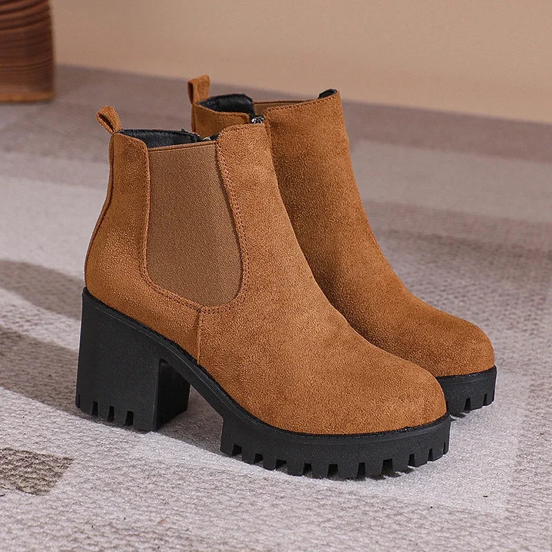 Elegant women's navy suede ankle boots with a chic block heel, ideal for winter outfits