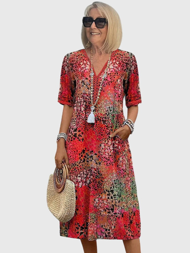 Flowy boho midi dress for women featuring a vibrant abstract print and stylish V-neck design.