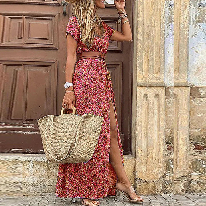 Vibrant floral print bohemian maxi dress for women, short sleeve, V-neck, and flowy silhouette with a chic side split.