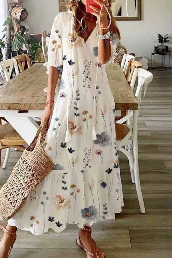 Women's boho floral print maxi dress with v-neck and playful tassels, perfect for summer fashion.