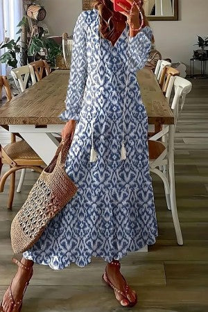 Bohemian long floral print maxi dress for women with a flattering v-neckline and stylish tassel details.