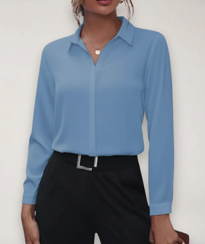 Close-up of a women's buttoned office blouse fabric texture, highlighting its quality and tailored fit.