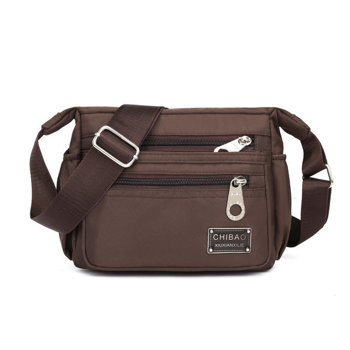 The women's nylon bag shown with essential items inside, emphasizing its practical storage