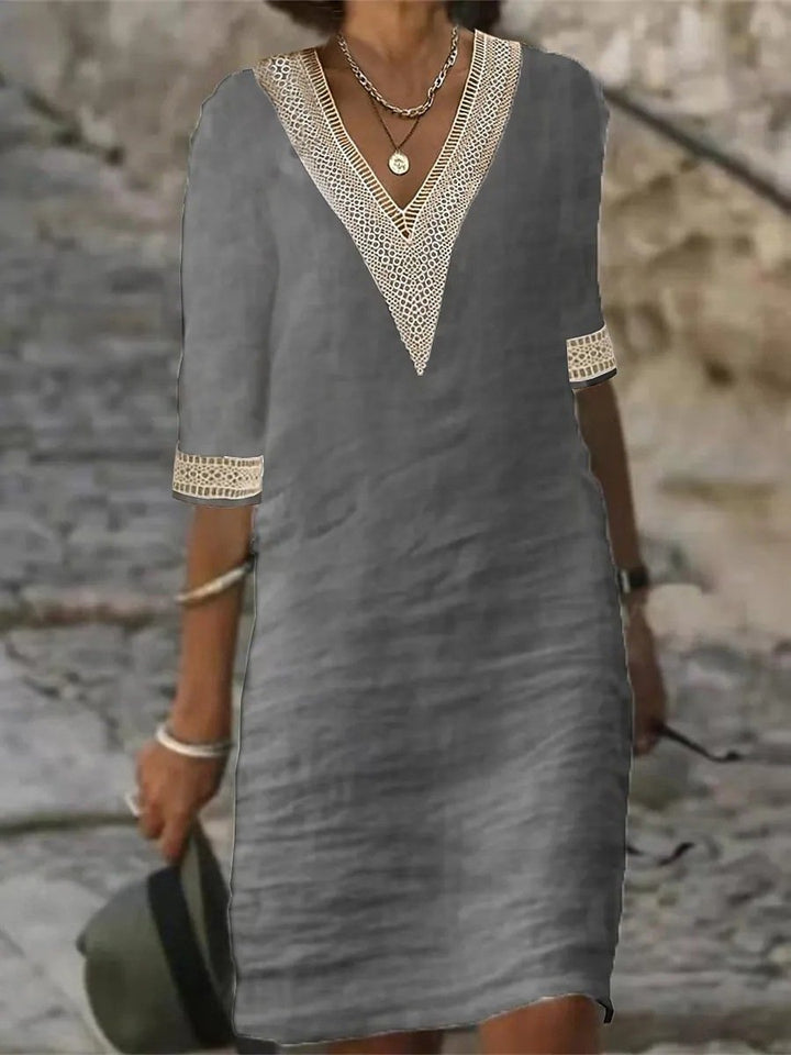 New women's relaxed fit V-neck dress, knee-length, with delicate lace trim and 3/4 sleeves, perfect for spring/summer.
