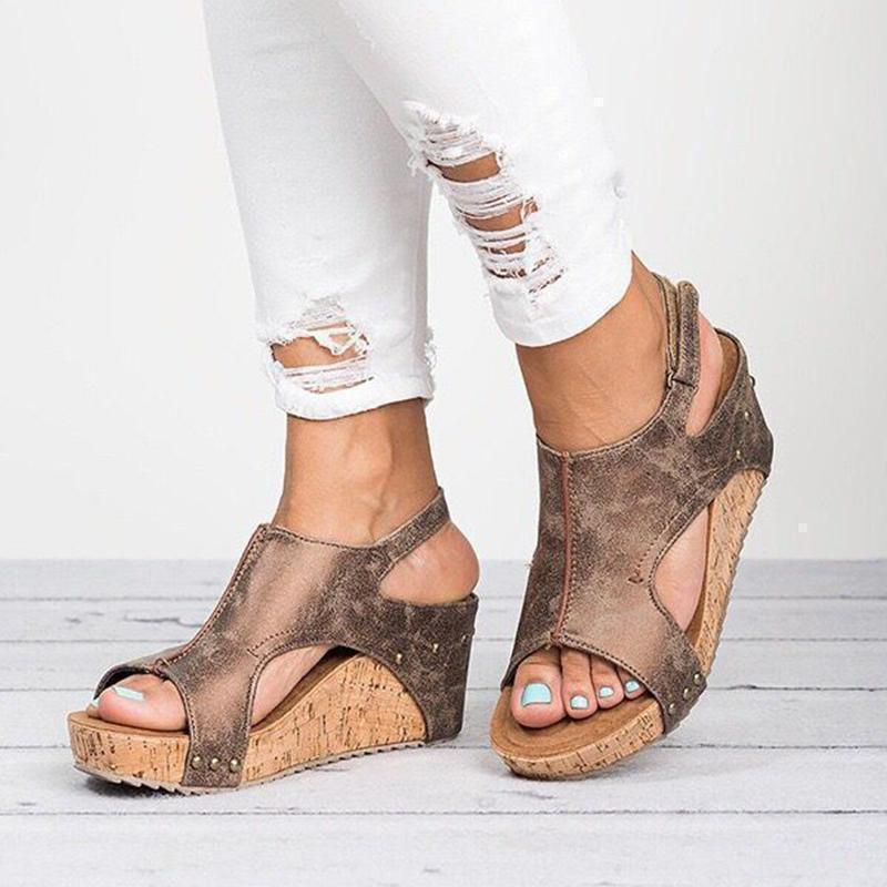Close-up of women's casual wedge heel sandals showing PU leather straps
