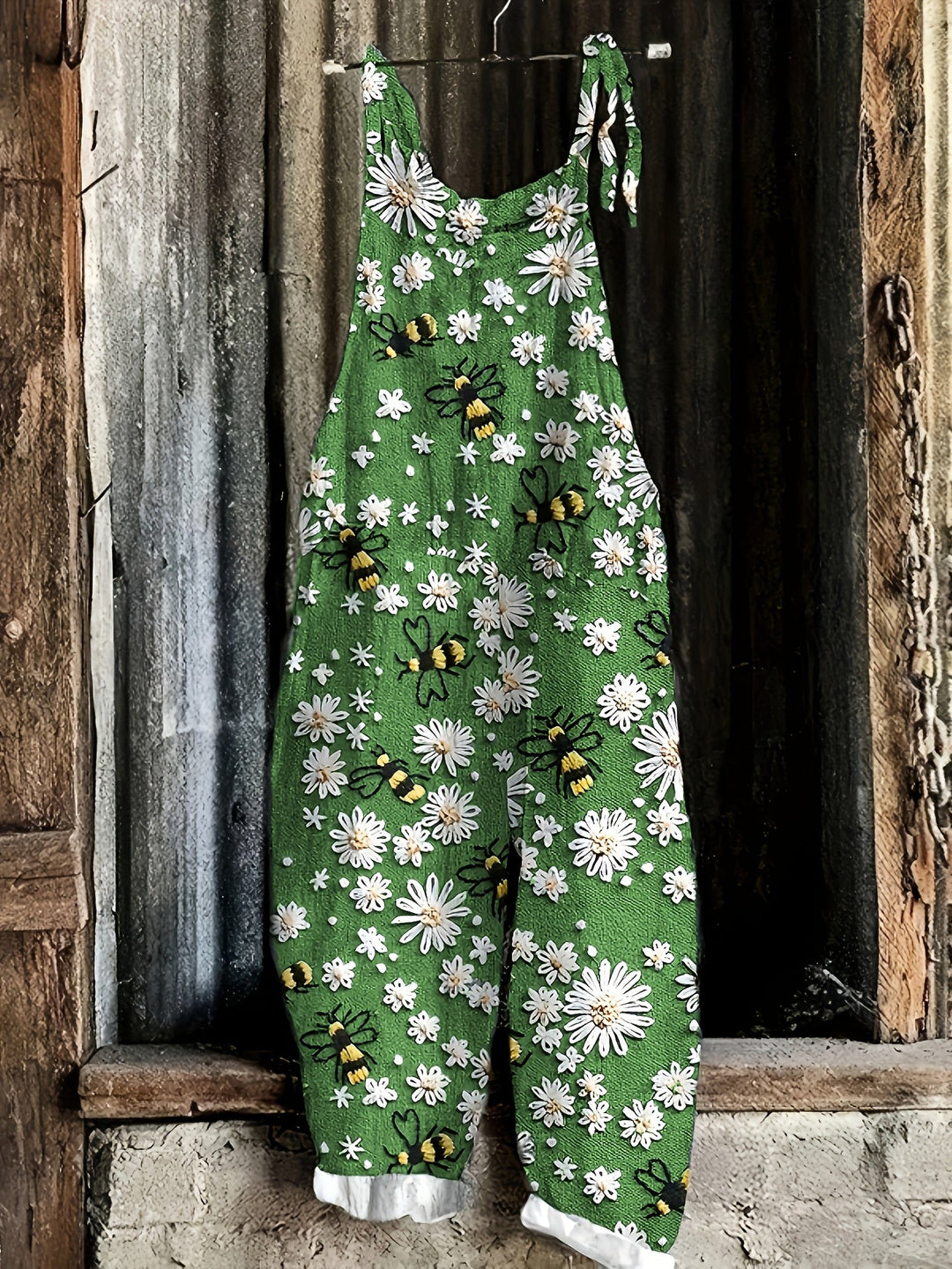 Sleeveless cropped women's jumpsuit, tie-shoulder, with fun daisy & bee print. Comfy summer casual wear.