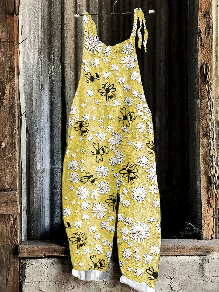 Whimsical daisy and bee print women's casual wide-leg jumpsuit, sleeveless, ideal for summer comfort.