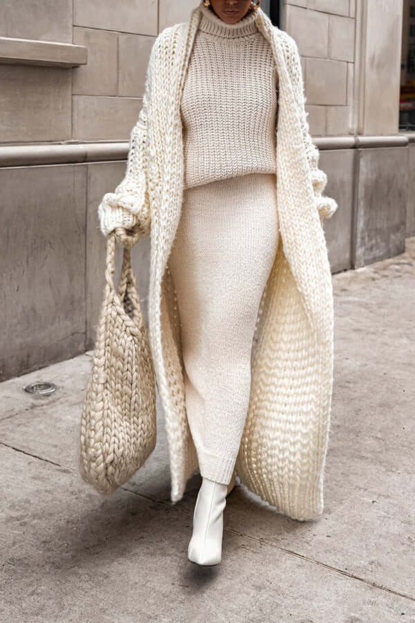 Close-up of knit cardigan texture from women's winter sweater set, showing intricate detail
