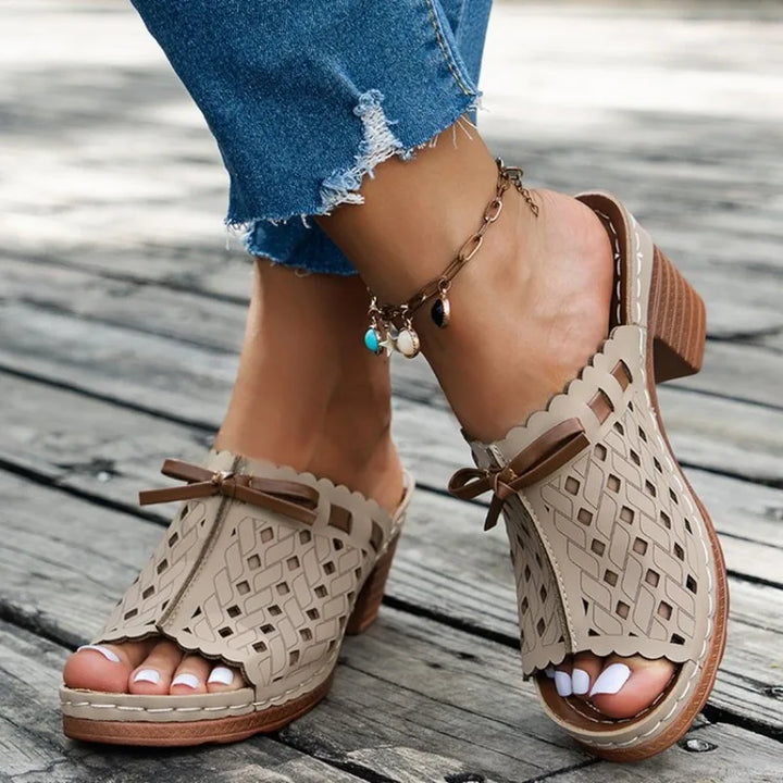 Stylish women's mules featuring a cutout design, block heel, and comfortable open toe.