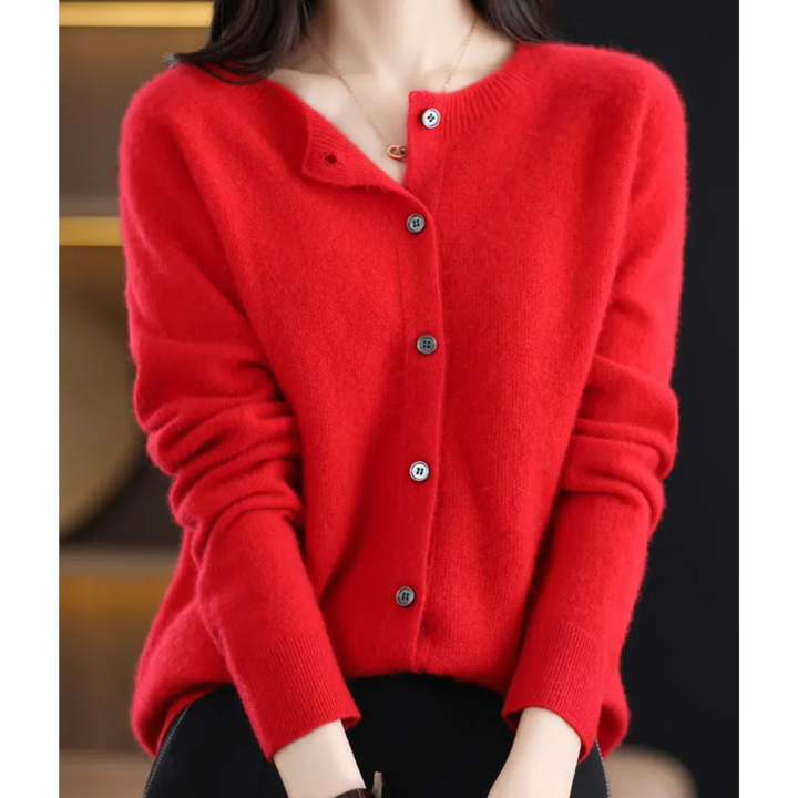 Closeup of women's merino wool sweater, featuring button detail and soft, comfortable texture.