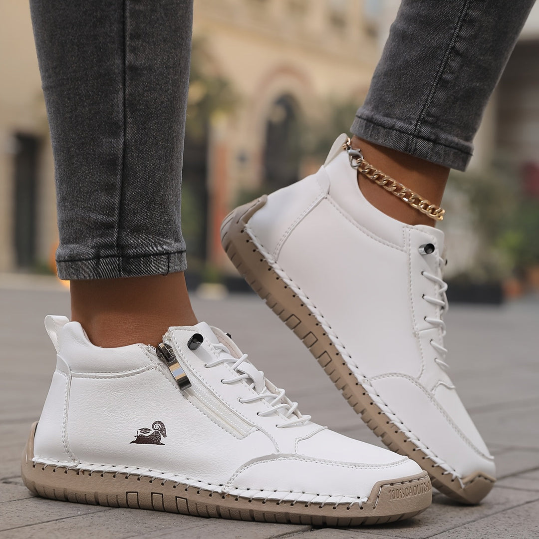 Studio shot of women's comfortable zip-up walking sneakers, showcasing their premium construction.