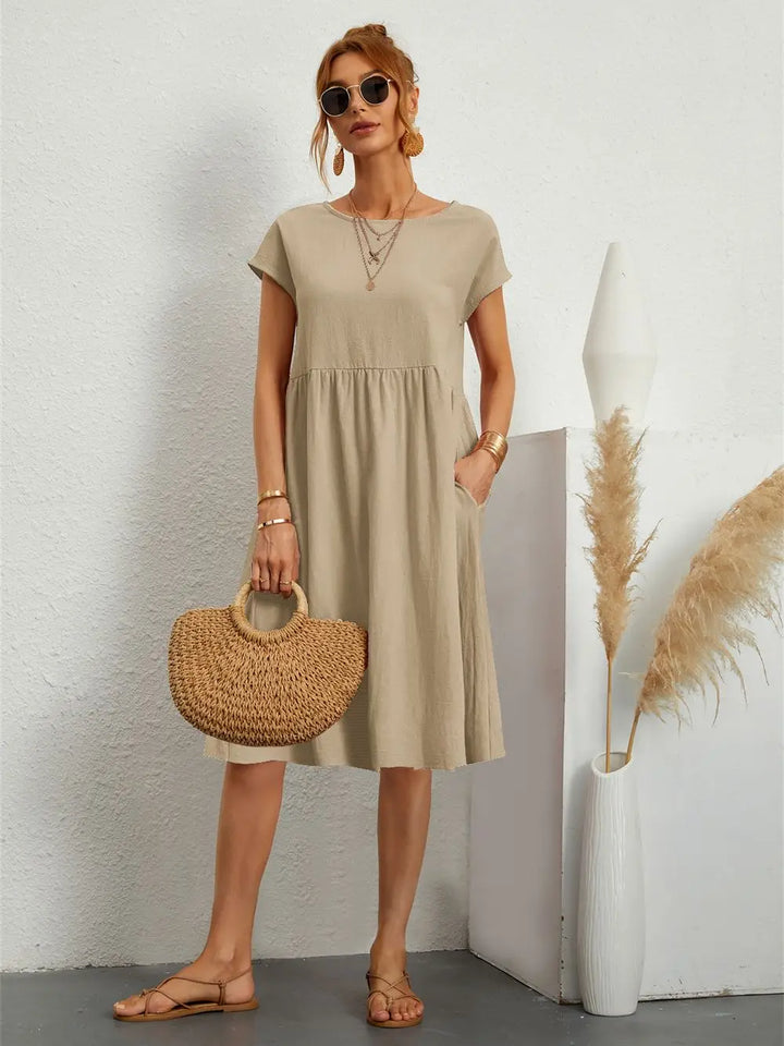 Essential pocket dress for women, a comfortable midi length perfect for casual and versatile fashion.