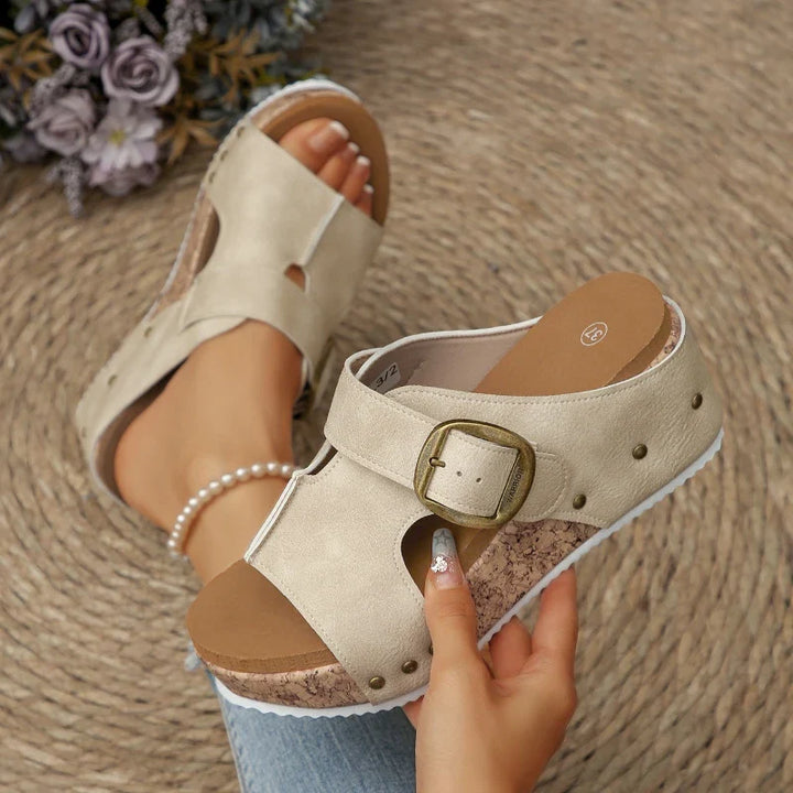 Side view of a women's orthopedic buckle slide sandal showing the cork platform and comfortable design