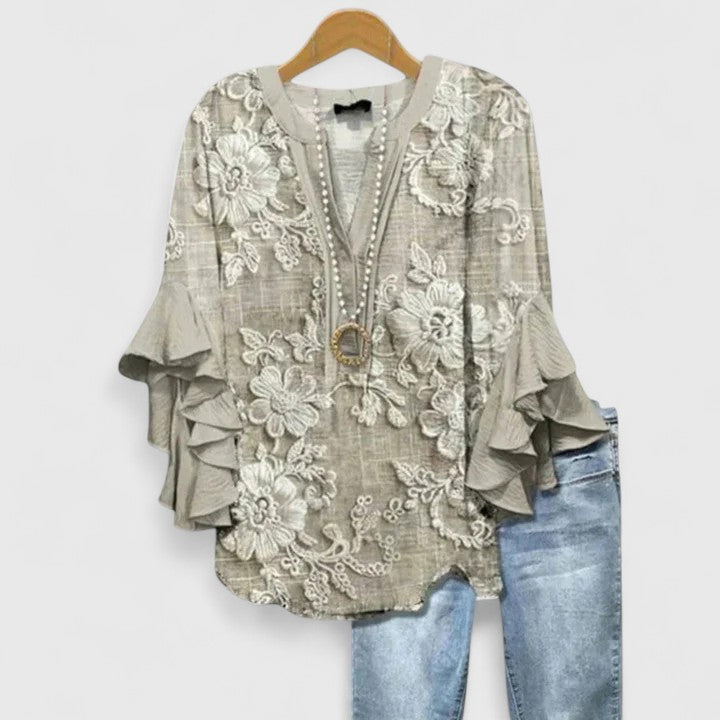Stylish women's spring blouse, floral print and ruffle sleeves for versatile everyday fashion.